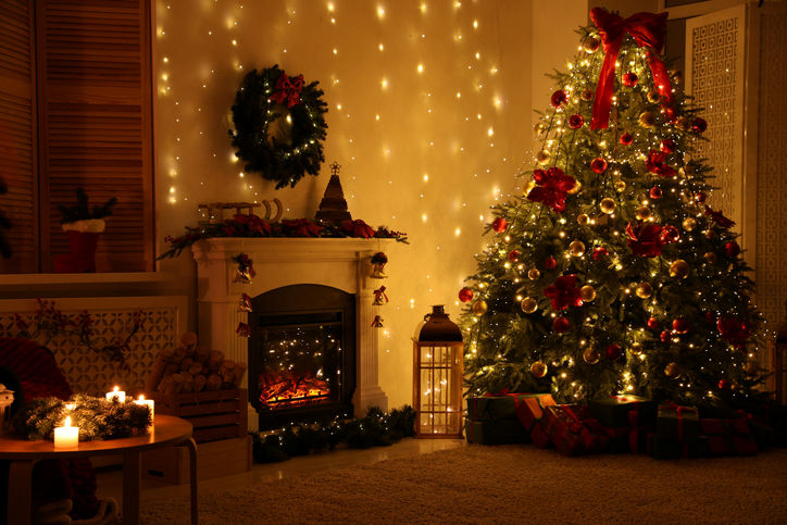 Christmas tree and fireplace surrounded by festive holiday decor